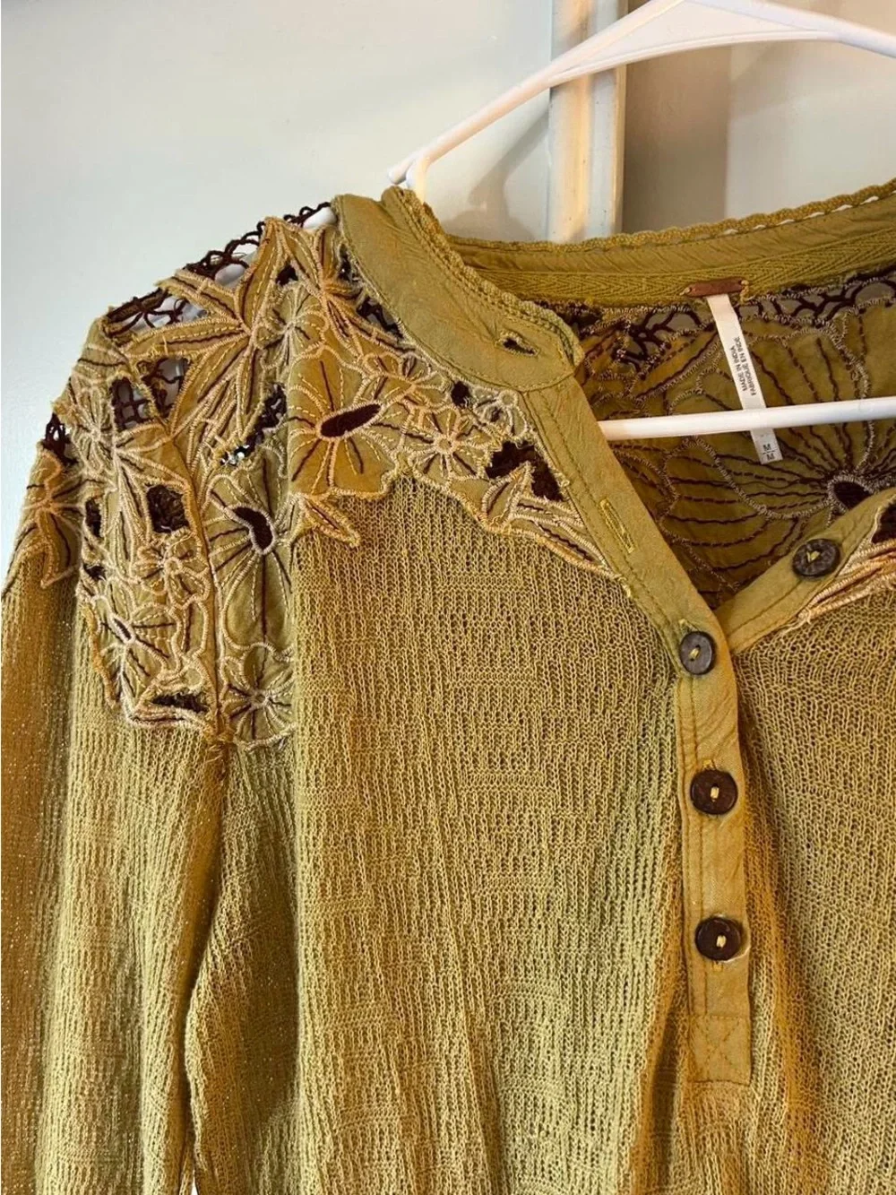 Free People embroidered henley long sleeve thermal top in an earthy green tone